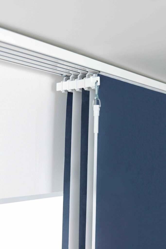 Close view of panel blind fabric hanging from a multi-channel track