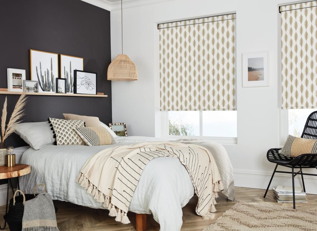 Bedroom with a neutral patterned roller blind against a dark feature wall