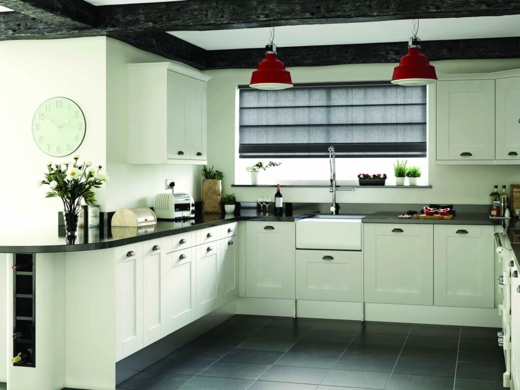 Striped Roman blind folded above a kitchen sink window