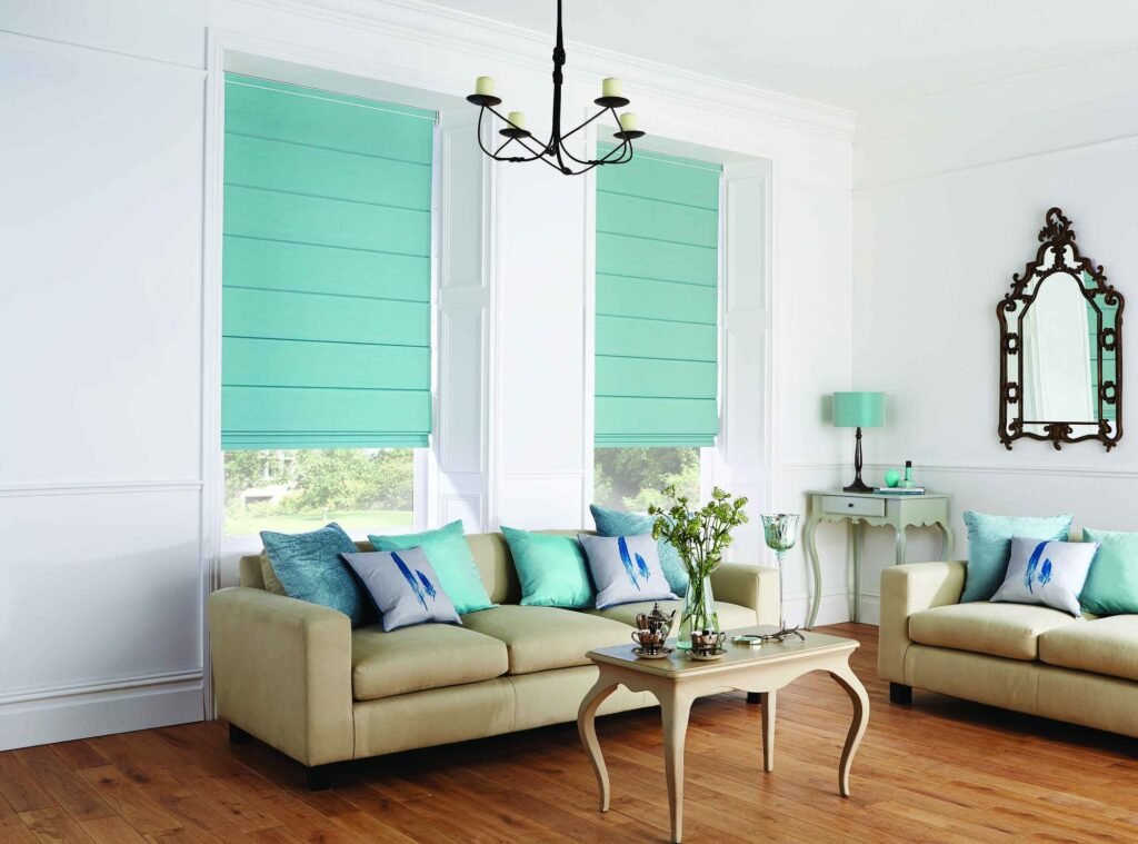 Pair of aqua Roman blinds in a living room with cream sofas