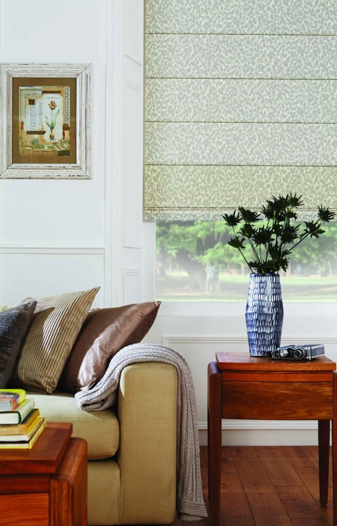 Neutral Roman blind beside a sofa and table lamp