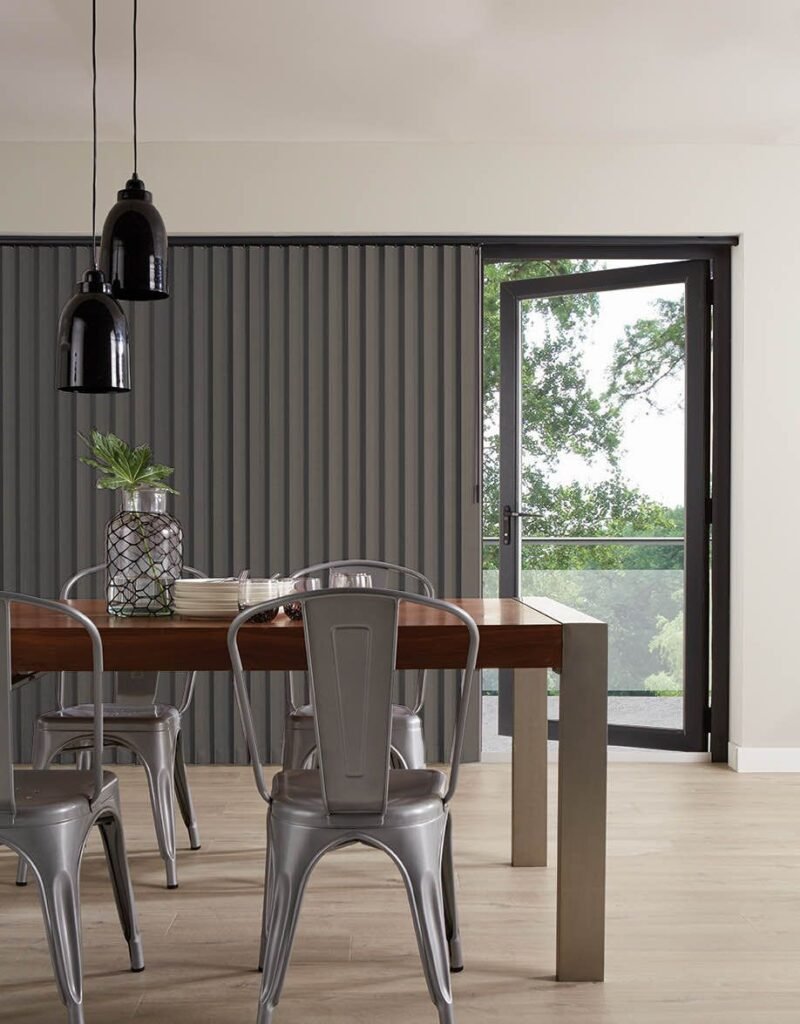Grey vertical blinds beside a glazed door in a dining room