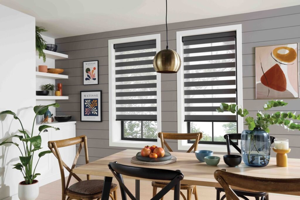 Grey vision blinds over a pair of windows behind a dining table