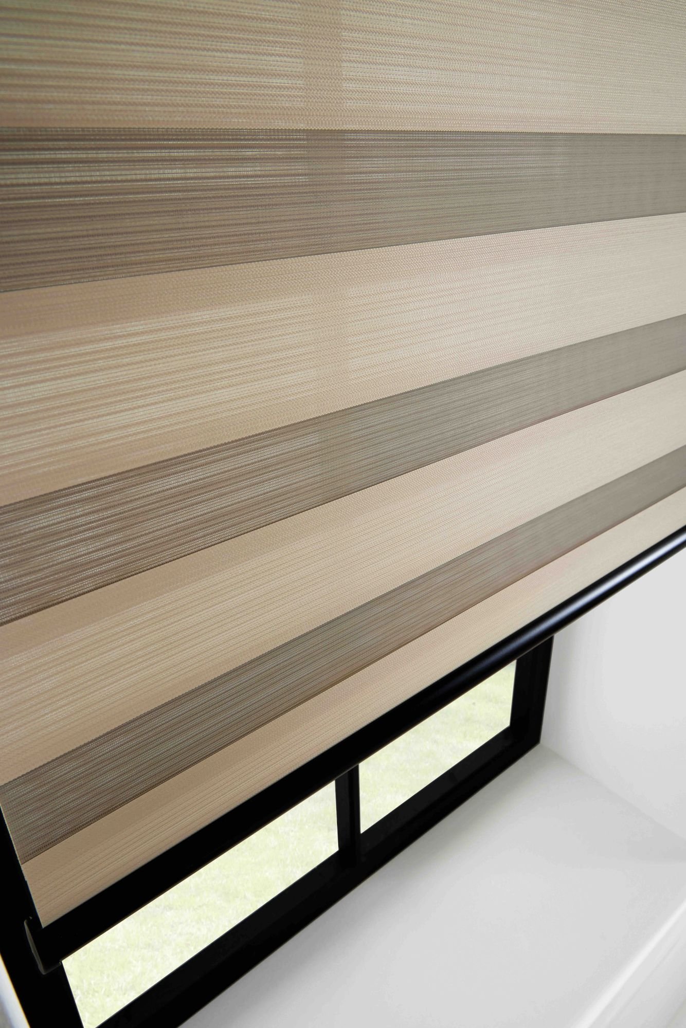 Close view of the sheer and solid bands of a beige vision blind