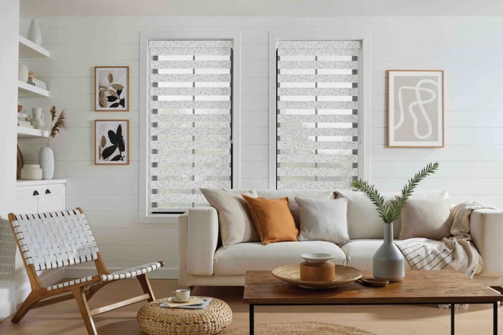 Natural-toned vision blinds in a living room with a rattan chair