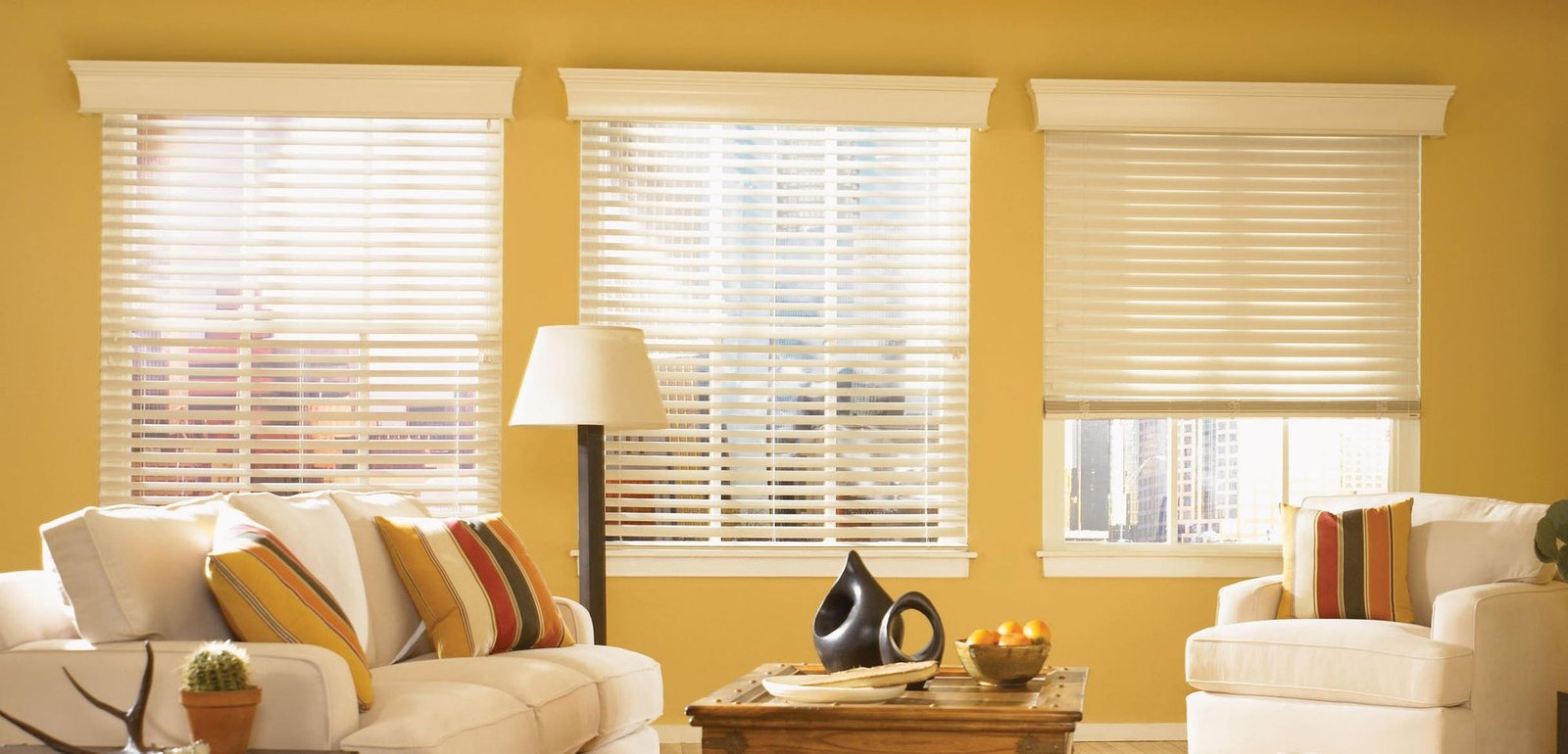 Three timber blinds across living room windows in warm afternoon light