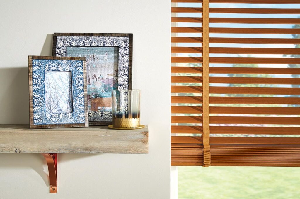 Honey-toned wooden slats beside a shelf with framed pictures